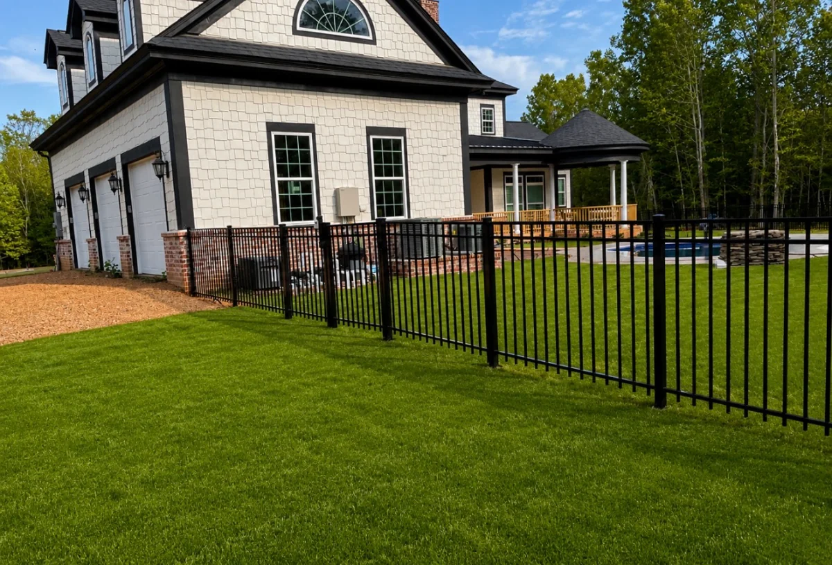 Aluminum 3-rail fence along a residential backyard